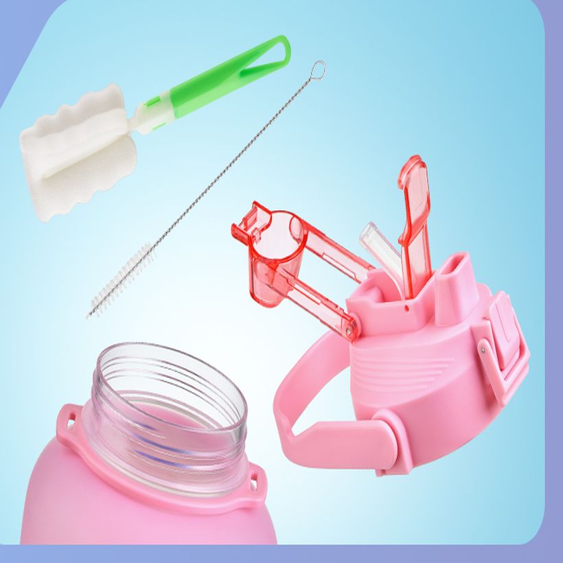The bottle's cap, straw and two included cleaning brushes