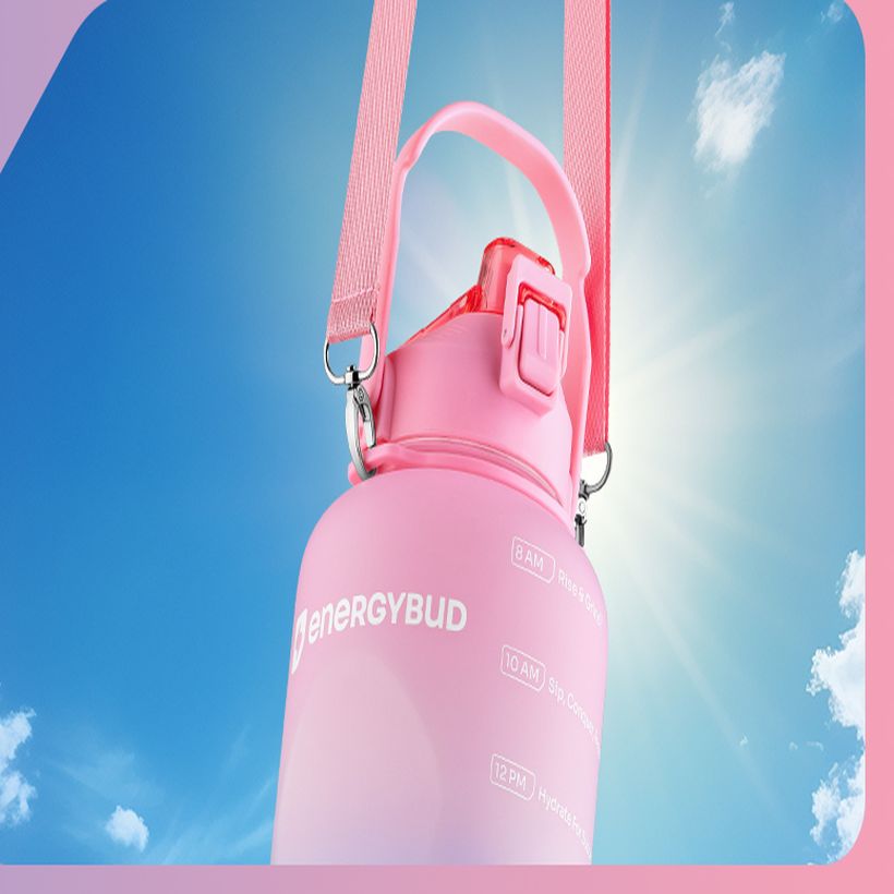 Pink EnergyBud bottle backlit against a blue sky
